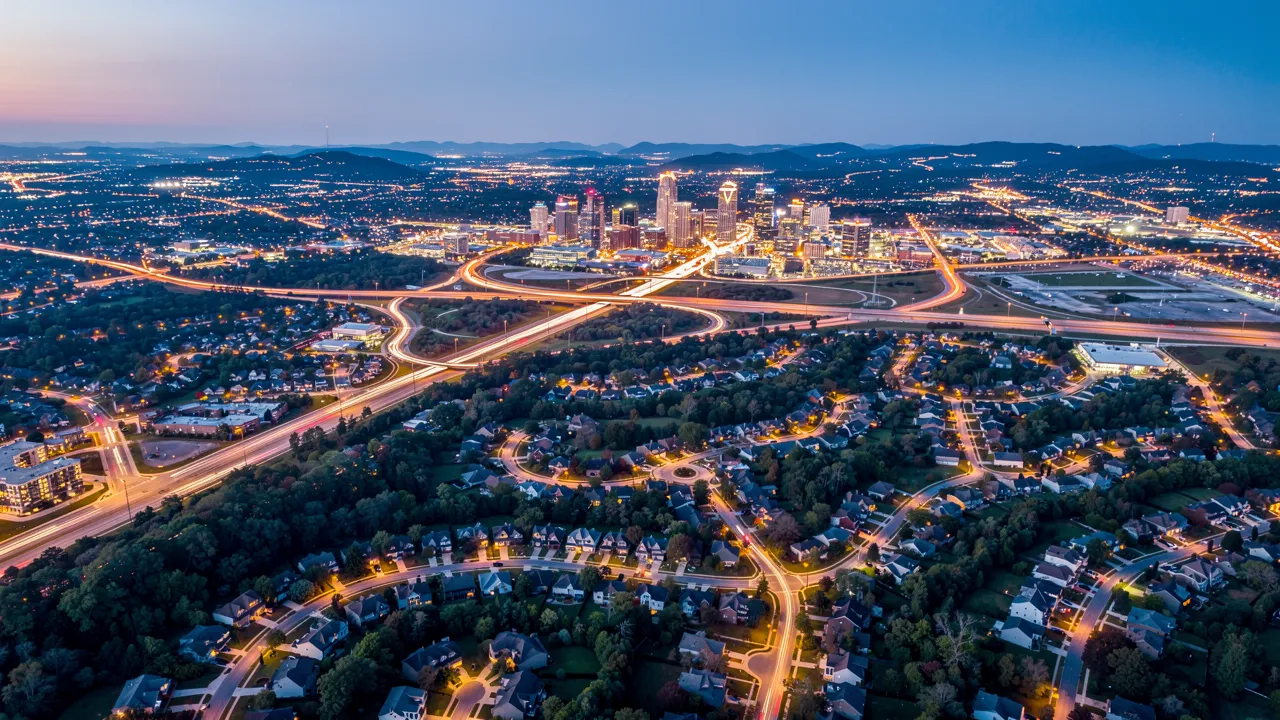 The greater Charlotte metro at dusk with warm house lights